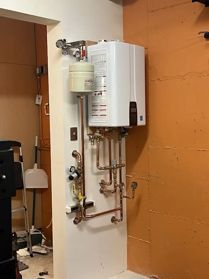 Plumbing technician inspecting water heater connections in Antioch